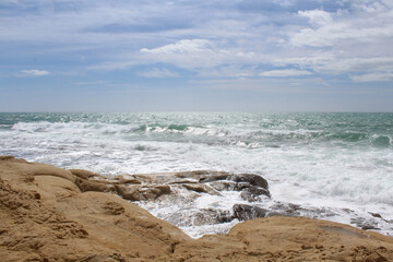 Fototapeta na wymiar beach and sea,natural background texture sky, sea and stone, Mediterranean coast in Spain, waves on the sea, 