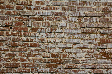 The wall is made of red brick. The texture.