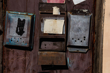 Old rusty mailboxes on the door.