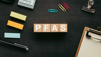There is wood cube with the word PFAS. It is an abbreviation for Per-and Polyfluoroalkyl Substances...