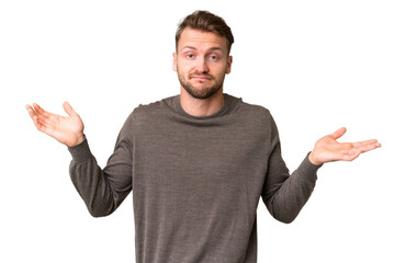 Fototapeta premium Young handsome caucasian man over isolated chroma key background having doubts while raising hands