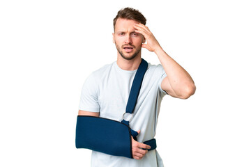 Young caucasian man with broken arm and wearing a sling over isolated chroma key background with surprise expression