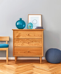 Wooden dresser in vibrant color in an interior design room composition. Minimalistic, chic interiors.