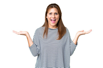 Middle age woman over isolated background with shocked facial expression