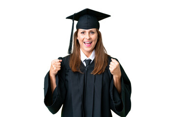 Middle age university graduate woman over isolated background celebrating a victory in winner...