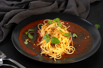 Delicious spaghetti served on a black plate