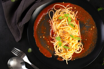 Delicious spaghetti served on a black plate