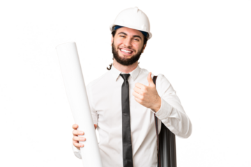 Young architect man with helmet and holding blueprints over isolated chroma key background giving a thumbs up gesture