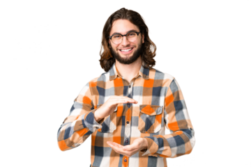 Young handsome man over isolated chroma key background holding copyspace imaginary on the palm to insert an ad