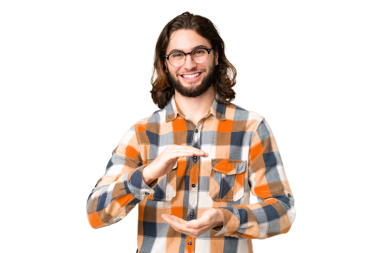 Young handsome man over isolated chroma key background holding copyspace imaginary on the palm to insert an ad