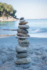 Stack stones on the coast of the sea in the nature. Cairn on the ocean beach, five pebbles tower....