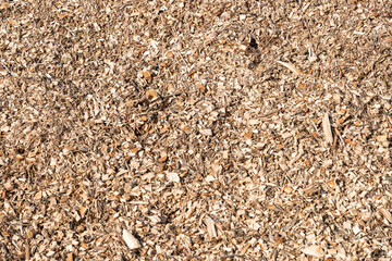 Pile of wood chips background, top view. Organic mulch. Waste from the woodworking industry, fuel...