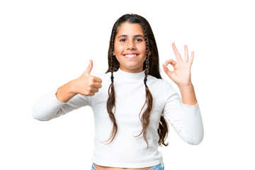 Young girl over isolated chroma key background showing ok sign and thumb up gesture