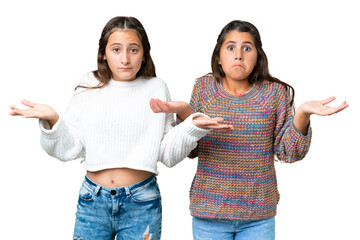 Friends girls over isolated chroma key background having doubts and with confuse face expression