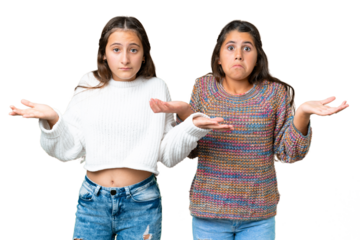 Friends girls over isolated chroma key background having doubts and with confuse face expression