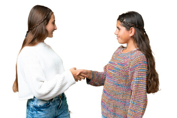 Friends girls over isolated chroma key background handshaking after good deal