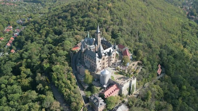 Aerial view of famous Castle Wernigerode, in beautiful golden evening light, Saxony-Anhalt, Germany. High quality 4k footage