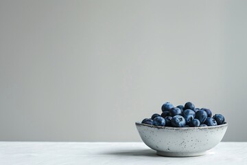 Blueberries in Speckled Ceramic Bowl on Minimalist White Background