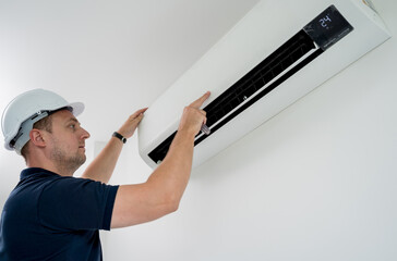 technician cleans air conditioner system in a modern apartment.