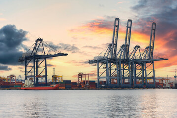 Obraz premium Logistic transportation sea freight, Cargo ship Cargo container in deep sea port at industrial estate for import export around in the world