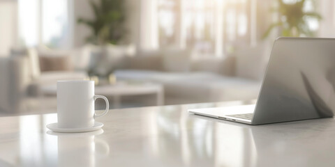 A white coffee cup sits on a table next to a laptop. The scene is set in a living room with a couch and a potted plant in the background. The coffee cup and laptop create a sense of productivity
