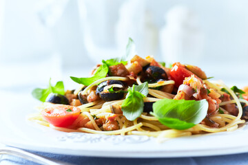 Spaghetti Pasta with Vegetables and fresh Basil on bright wooden Background.