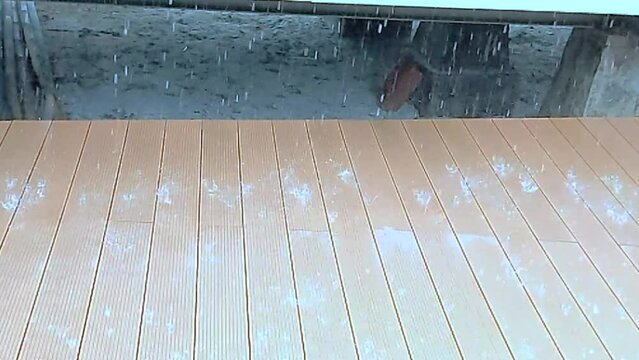 Slow motion. Raindrops falling and transparent water poured down from the roof 