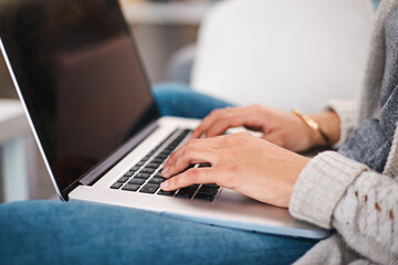 Laptop, hands and woman typing in apartment for online research with work from home creative job. Technology, keyboard and female freelance copywriter with website or internet project in house.