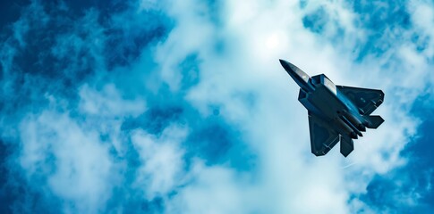 Advanced Fighter Jet Soaring High in Cloudy Blue Sky