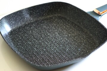 Close up image of grill pan isolated on white background, kitchen and cooking equipment