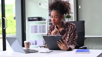 Businesswoman Analyzing Finance on Tablet and Laptop at modern Office Desk tax