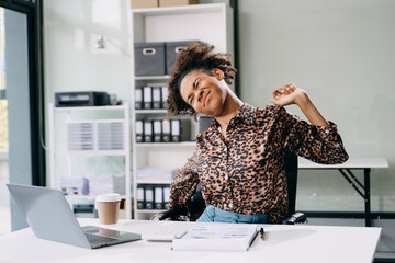 Overworked young businesswoman office worker suffering from neck pain after had a long day at her...