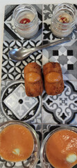 aperitive food with croquetes gazpacho and other food stuff