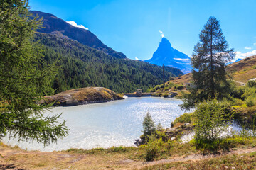 View of Moosjisee lake and Matterhorn mountain at summer on the Five Lakes Trail in Zermatt,...