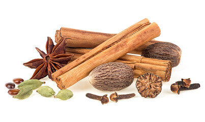 Traditional Christmas spices - cinnamon sticks, star anise, cloves, nutmeg and cardamom pods isolated on a white background. - Powered by Adobe