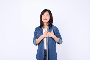 Asian woman wearing denim jean is expressing delight against a white background.
