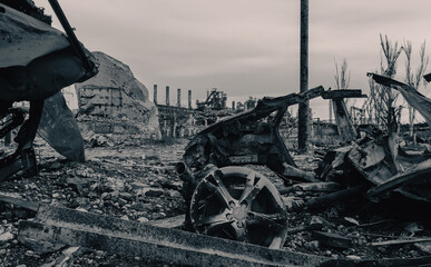 burnt cars and destroyed buildings of the workshop of the Azovstal plant in Mariupol