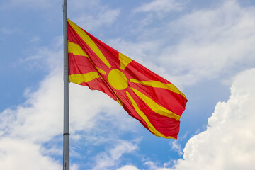 Flag of North Macedonia against blue sky