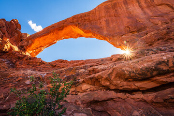 The sun star shining through the North Window Arch in the Arches National Park in the Moab, Utah,...