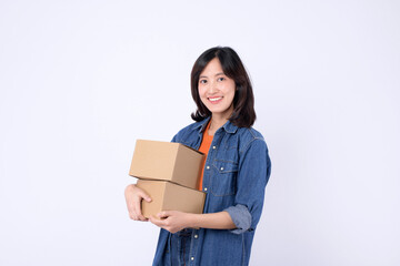 young asian woman wearing orange t-shirt and denim shirt holding parcel box isolated on white studio background, Delivery courier and shipping service concept.