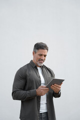 Happy vertical portrait of Latin Hispanic mature adult professional business man, smiling Indian...