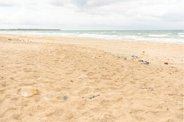 Sri Lanka, Bottles of plastic and garbage on the sand on the beach near the ocean, sea pollution catastrophe.