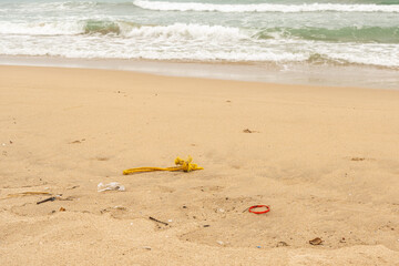 Obraz premium Sri Lanka, Bottles of plastic and garbage on the sand on the beach near the ocean, sea pollution catastrophe.