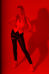 Slender blonde woman in red light