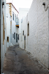 traditional alley of the upper city with white houses Patmos island greece
