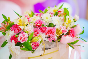 Bouquet of delicate pink and white flowers in a bag. Original and convenient packaging for a...