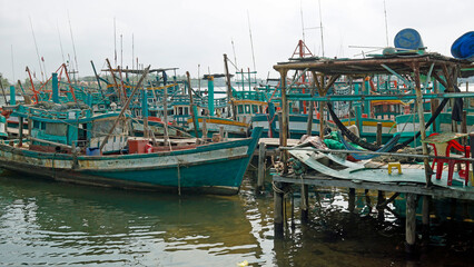 colorful fisher boats in a harbor in kampot