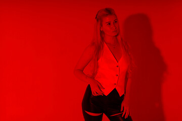 Beautiful young blonde woman through red filter