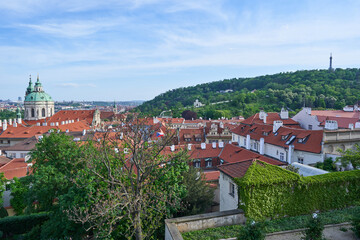 Red roof tops of the Lesser town in the Prague, capitol of Czech Republic. Pitoresque part of the big city with old buildings and beautiful historical architecture, popular between tourists from world