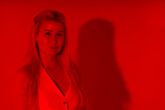 Beautiful young blonde woman through red filter
